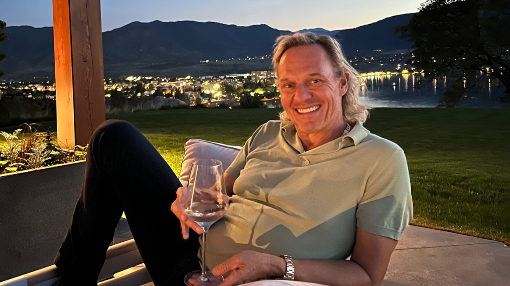 Frank Schilling posing holding a glass of Aphrodise