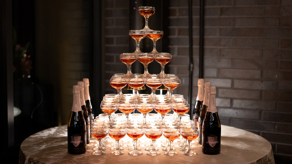 Wine glasses filled with Aphrodise, stacked in a tower