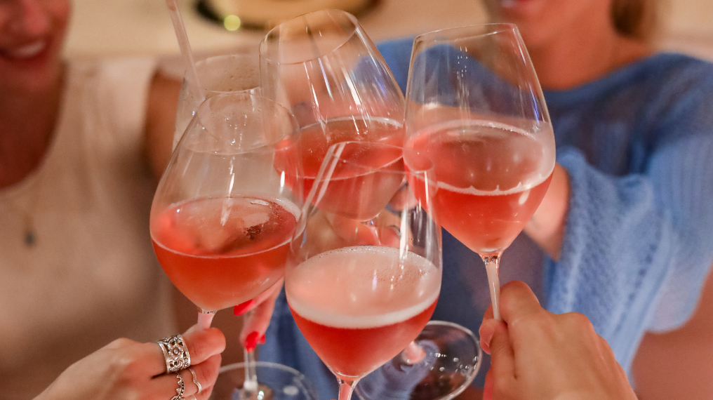 Group of people cheersing glasses of Aphrodise