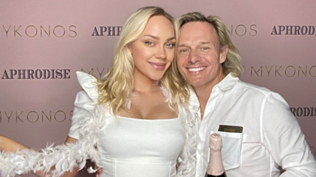 Gabi Petrylaite and Frank Schilling smiling infront of an Aphrodise back drop